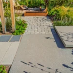 Natural stone and concrete paver patio surfaces compared in a Vancouver yard
