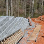 Leaning retaining wall showing visible movement and separation between wall sections